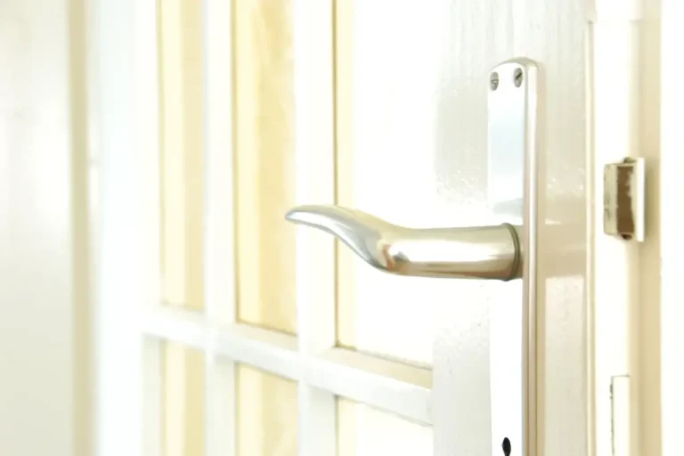 How to change a uPVC door lock in Lancing – white door with a lever handle on a long backplate, Locksmith Lancing guide to barrel, handle and multipoint replacement