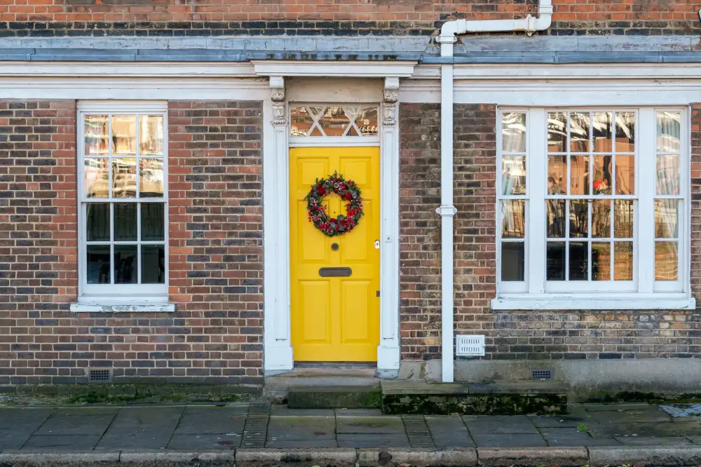 Yellow front door on a red-brick Victorian house – residential locksmith Lancing front door security check by Locksmith Lancing